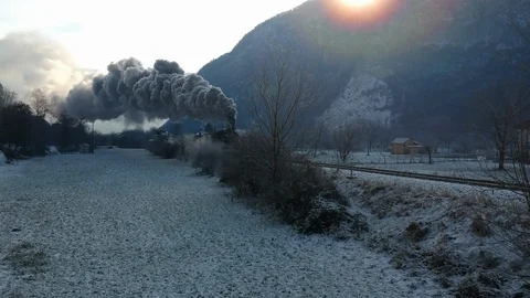 Historic steam train rolling through the snowy valley in a winter day Stock Footage 121428915