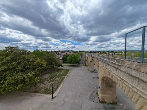 Historic stone aqueduct with cloudy dramatic sky 스톡 사진
