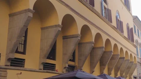 Historic Stone Arch Arcade Along Traditional Building Facade in Florence Ital Видео 340749265