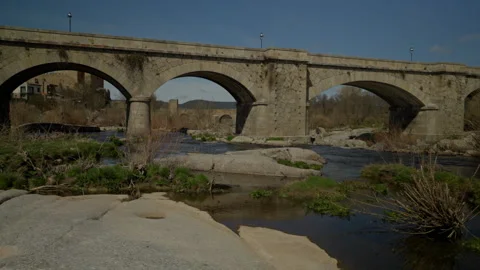 Historic stone arch bridge over the Tormes river in Puente del Congosto Stock Footage 335462726