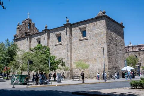 Historic stone architecture of two temples in Guadalajara city center on sunny Stock Photos