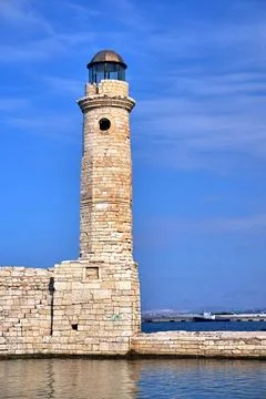 Historic stone lighthouse in the harbor of Rethymno on the island of Crete Stock Photos