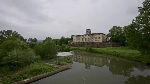 Historic Stone Mill Set Within Lush Environment Featuring Reflective River Stock Footage 325984440