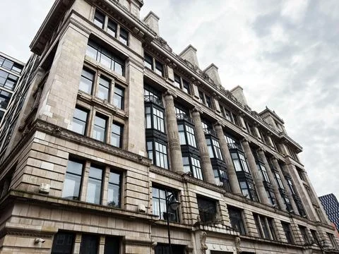 Historic stone office building with classical columns and large windows in .. Stock Photos
