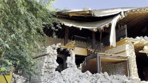 A historic stone wall building is damaged in an earthquake Stock Footage 246161604