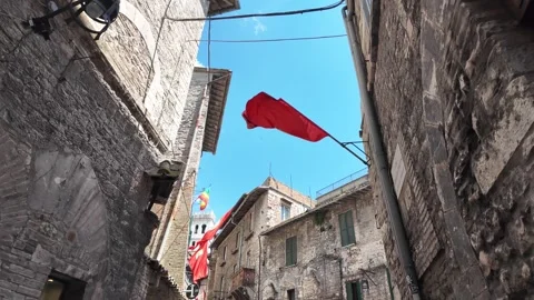 Historic streets of Assisi decorated with flags in Italy Stock Footage 338009238