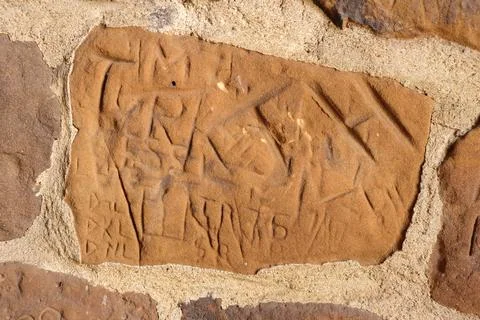 Historic Text Etching on Rustic Limestone Castle Wall Detail Stock Photos