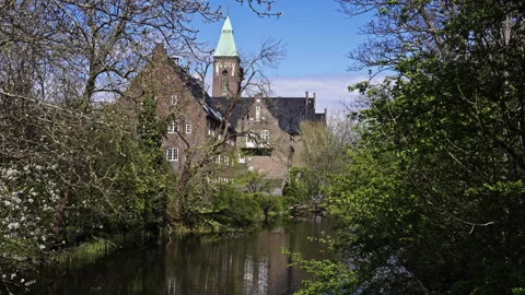 Historic Tower and Brick Facade Seen Through Spring Blossoms Stock Footage 309424919
