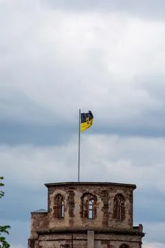 Historic tower with flag under cloudy sky Stock-Fotos