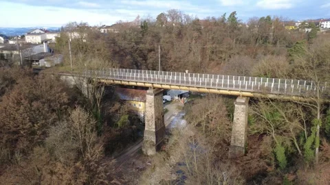 Historic train crossing the bridge over the river aist Stock Footage 321599646