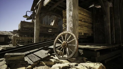 Historic western scene featuring wagon wheel and aged saloon entrance signs Stock Footage 342432306