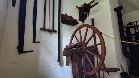 A historic wheelwright display shows wheel parts and vintage tools indoors Stock Footage 336505551