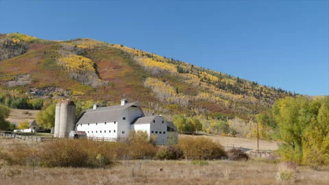 Historic white McPolin Barn with fall colors in October, Park City, Utah. Video stock 221221048