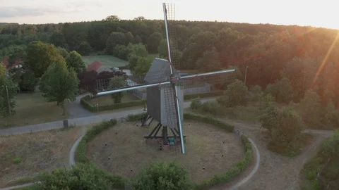 Historic Windmill  mill in large forest in belgium at sunset flying up with 4k Stock Footage 123022172
