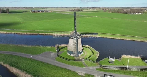 Historic windmill by the river called in the Netherlands. Stock Footage 246766948
