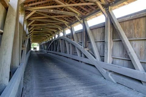 Historic Wooden Covered Bridge Interior With Wooden Trusses on a Sunny Day Stock Photos