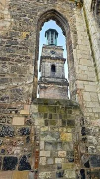 A historical brick building with a clock tower, showcasing medieval architecture Stock Photos