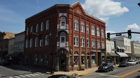 Historical building dominates the corner in this low aerial view of the Stock Footage 116623683