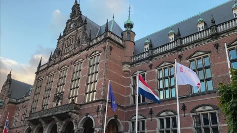 Historical Building of the University of Groningen with Flags waving in the Wind Video stock 163166364