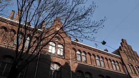 Historical building in the windows of which the sun's rays are reflected Stock Footage 274398090