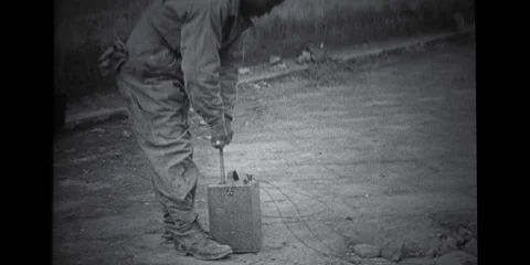Historical Footage - Man exploding building with dynamite plunger Video stock 91859232