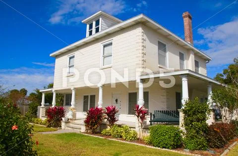 Historical home with unique porch pilars with blue sky Stock Photos