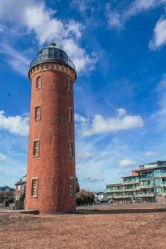 Historical lighthouse tower built from red bricks. Stock Photos