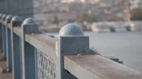 Historical metal bridge railing with rounded details overlooking a bustling.. Stockbeeldmateriaal 332882288