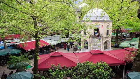 Historical mosque, plane trees and cafes in Koza Han silk bazaar garden Stock Footage 131368644