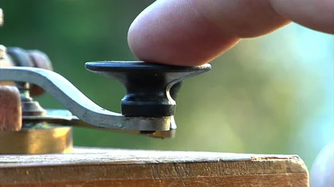 Historical old telegraph operator taps out message using morse code Stock Footage 148403759