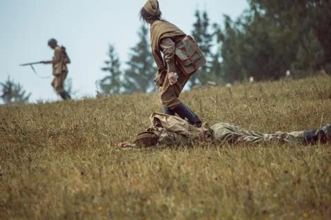 Historical reconstruction second world war. The nurse next to the wounded. Stock Photos