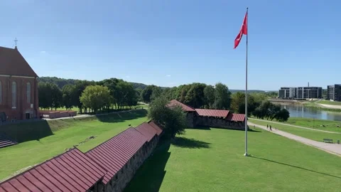 Historical State flag of Lithuania is waving next to Kaunas castle. Lithuania Stock Footage 248767708