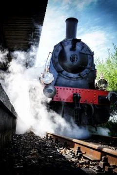 Historical steam engine train in motion Stock Photos