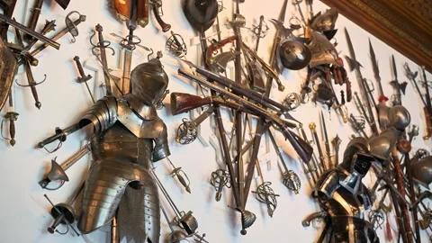 Historical weapons and armor collection displayed on a wall in a museum cre.. Stock Footage 339425489