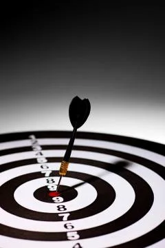 A hit dart in the middle at the target. Stock Photos