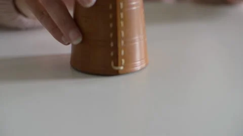 Hit of a dice cup on the table and checking what dices show Stock Footage 153661135