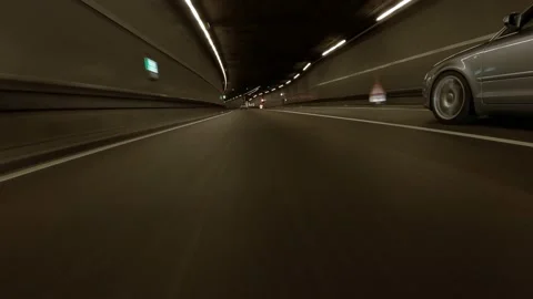 Hit the road - driving through a tunnel next to a another car in low Vídeo Stock 162938522