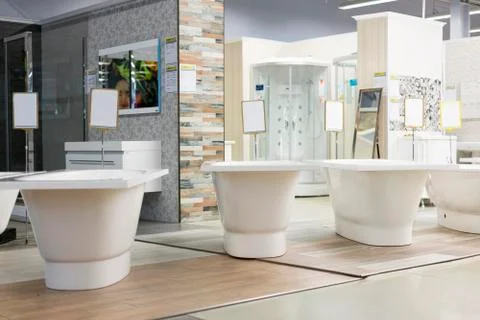 Hite bath in the building store. baths in the plumbing store. Sanitary engine Stock Photos