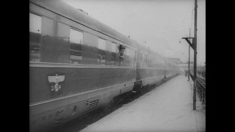Hitler gets onto train, Swastika flags are massed in hall Stock Footage 252518712