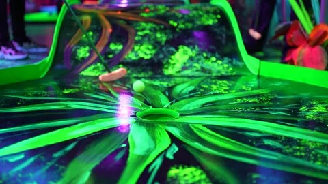 Hitting and missing the minigolf hole at a colorful led pitch1 Stock Footage 219938403