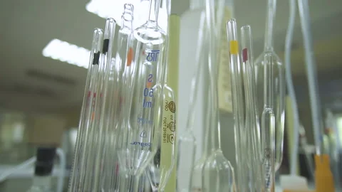 Hitting the camera on the test tubes and tubes standing in a heap on the table Stock Footage 153863347