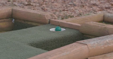 Hitting Colorful Golf Ball on Mini Golf Course with Putter Video stock 88226580