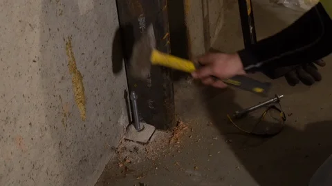 Hitting Concrete Anchor with Hammer Video stock 100693801