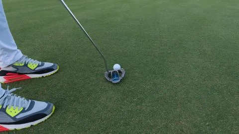Hitting golf ball to hole 스톡 사진