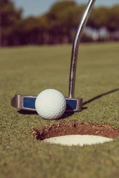 Hitting golf ball to hole 스톡 사진