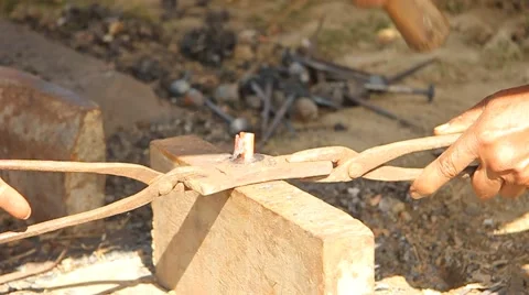 Hitting hot nail with hammer Stock Footage 53101706