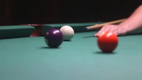 Hitting a white ball with a billiard cue in video Stock Footage 339029314