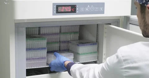 HIV reagent development in a laboratory. Scientist or chemist puts tray with Stock-Footage 269461637