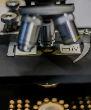 HIV sample analyzed under a microscope. Stock Photos