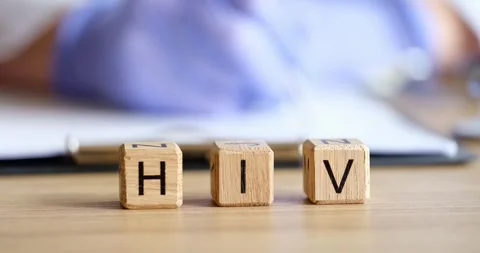 HIV text on cubes against background of working doctor Stock Footage 244704809